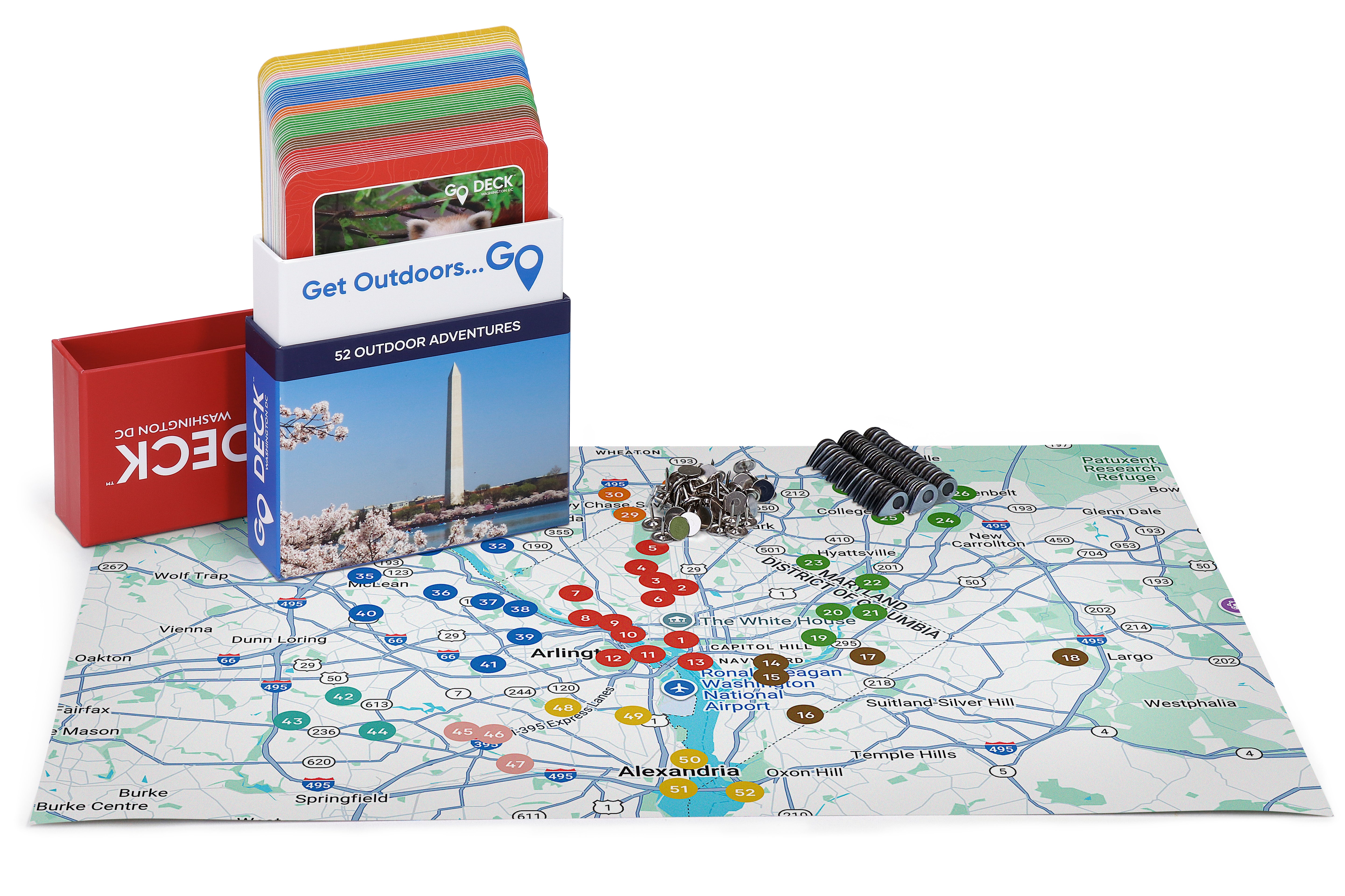 Outdoor adventure game set with map, cards, and magnets on a white background