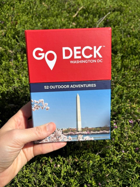 Go Deck Washington D.C. card set held in front of green foliage