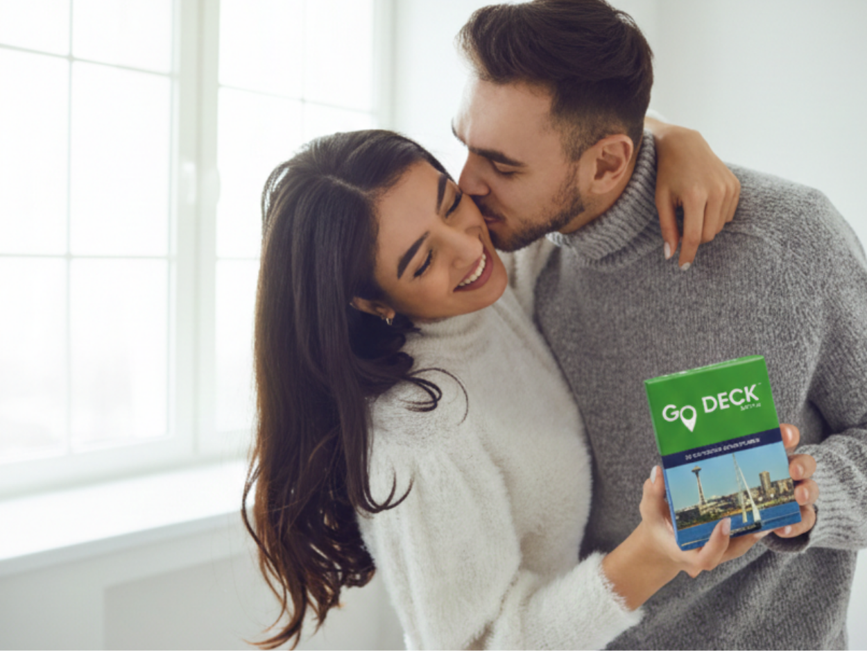 Man and woman embracing, with the woman holding a product labeled 'GO DECK'.